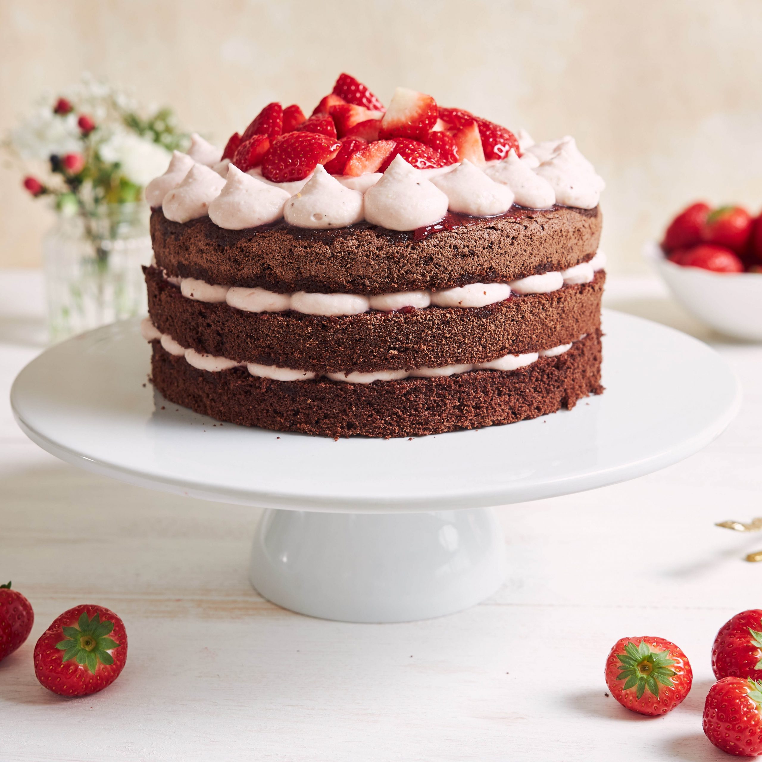 The delicious and sweet cake with strawberries and baiser on a plate